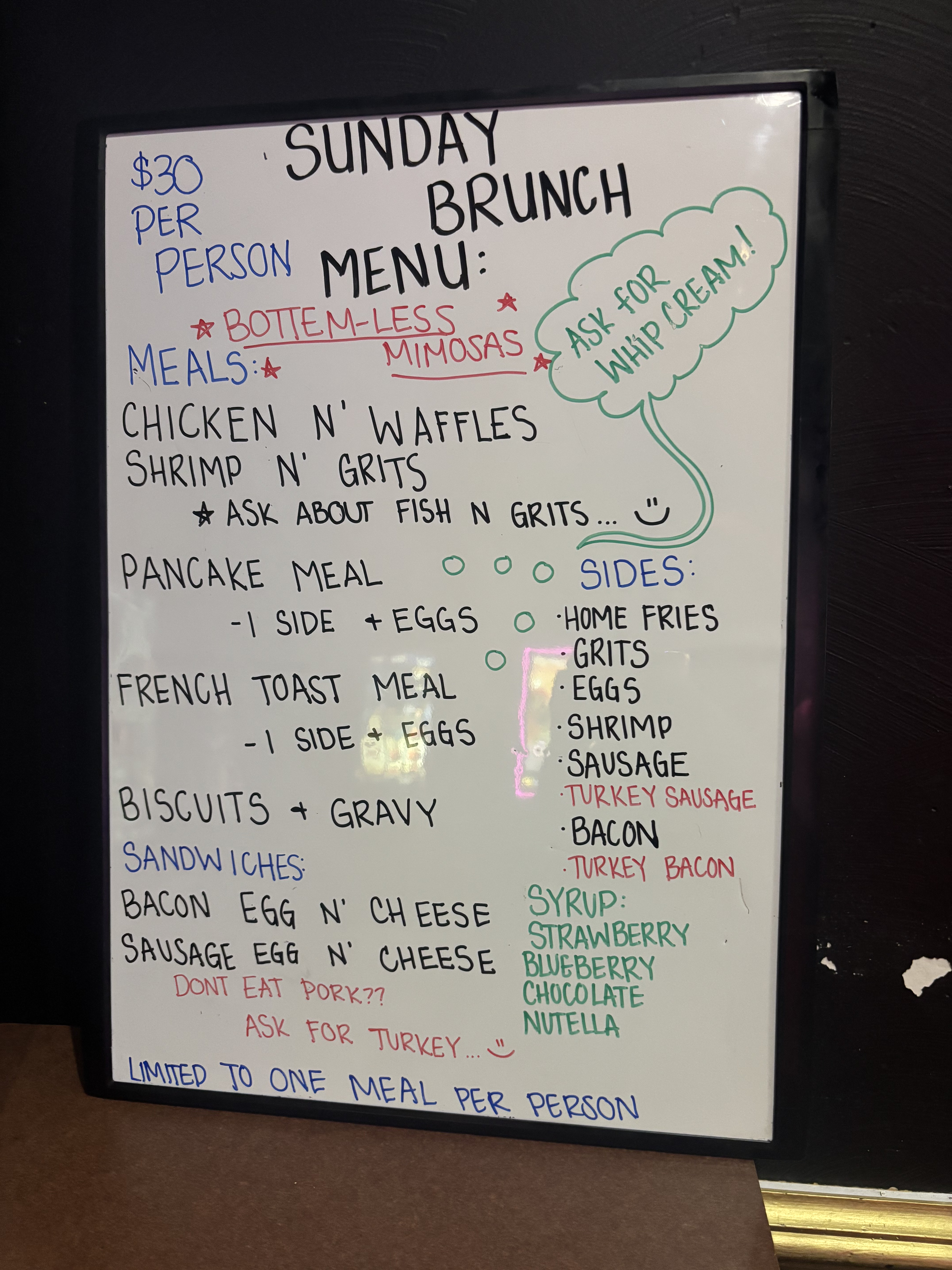Handwritten Sunday brunch menu board at GKL Bar & Grill